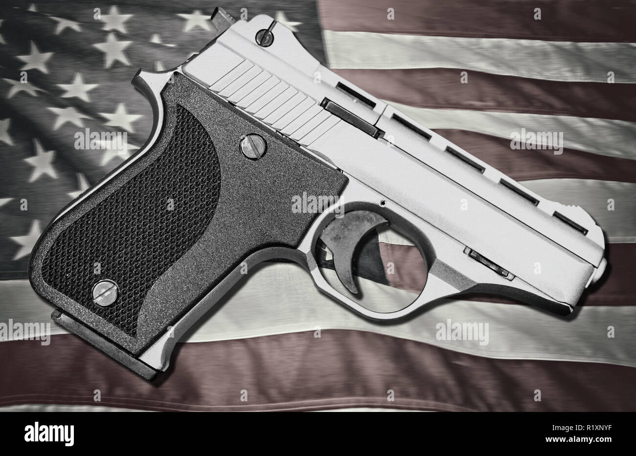 Handgun on top of American Flag Stock Photo