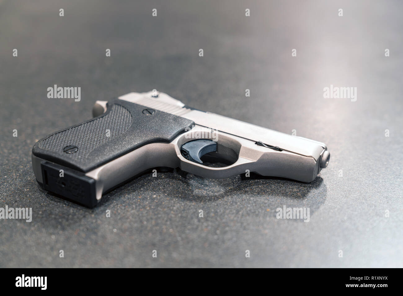 Small Silver Handgun Isolated on Dark Table Stock Photo Alamy