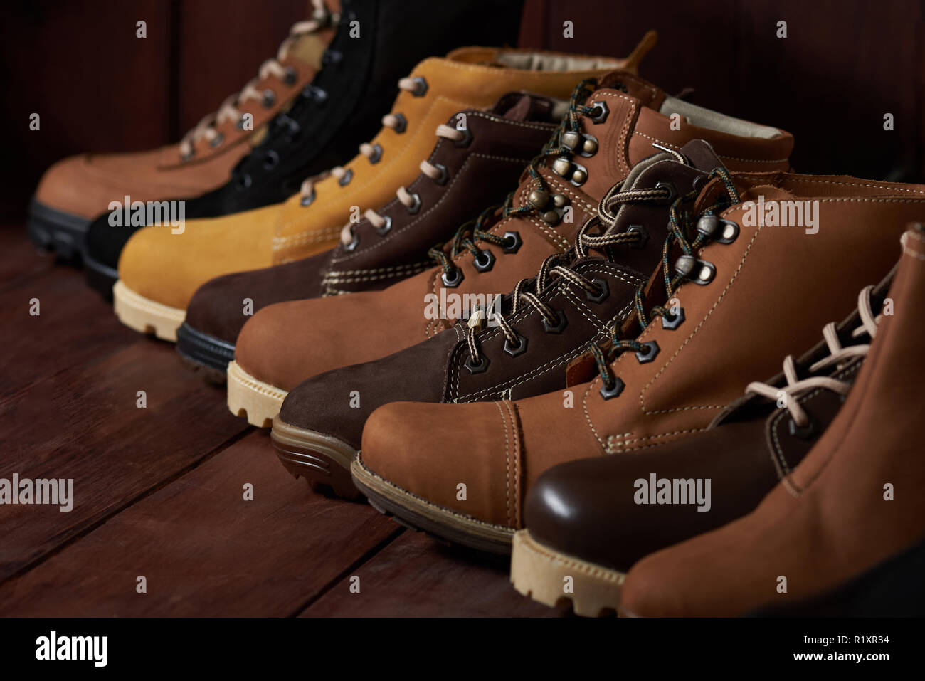 Brown leather shoes stand on wooden background Stock Photo