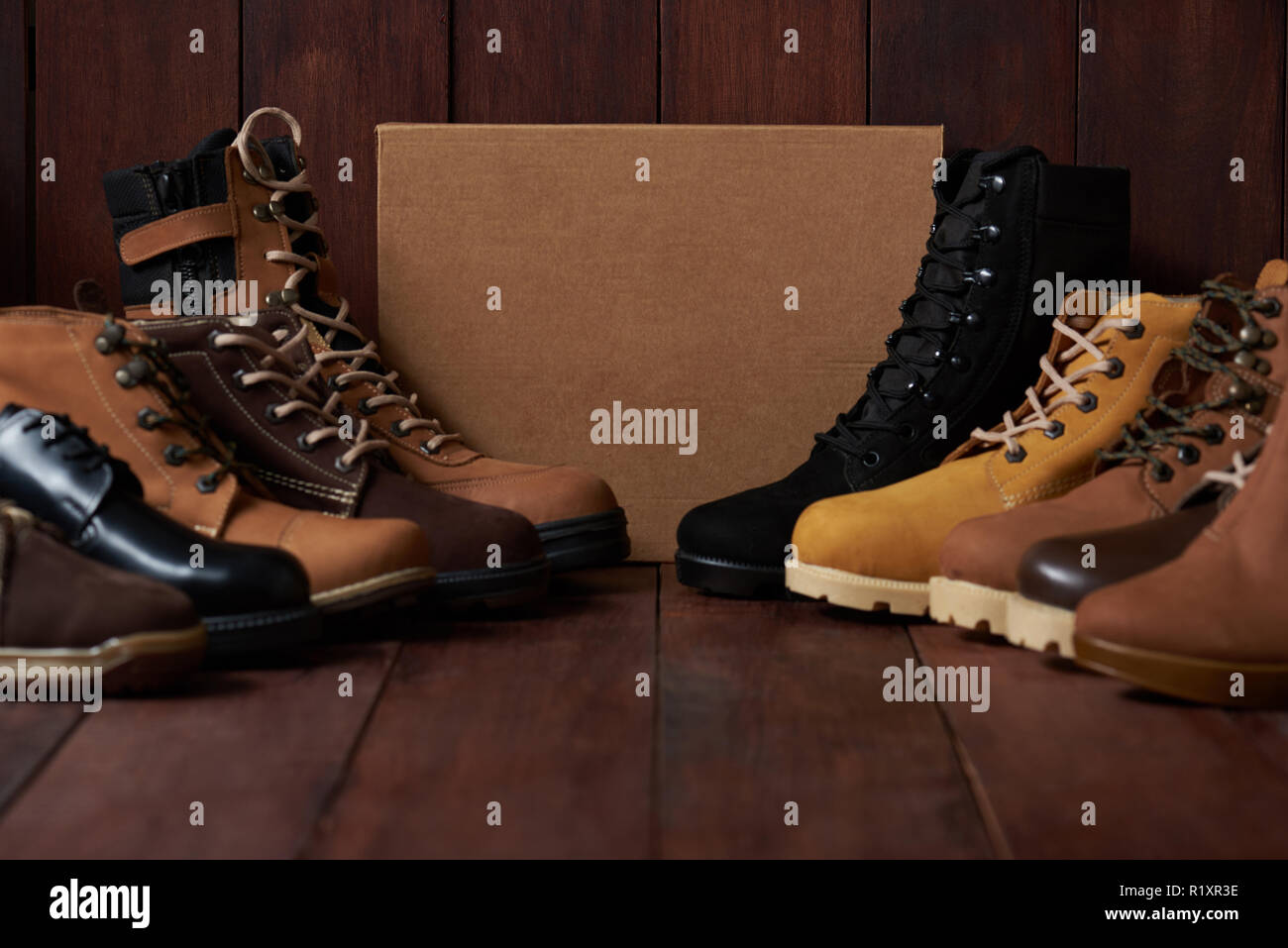 Men footwear theme. Shoes stand with shoe box in center of wooden  background Stock Photo - Alamy
