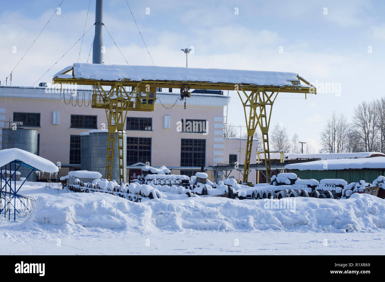 Snow-covered working area with the wheelsets and crane on railway hub in the winter (city of Dno, Russia) Stock Photo