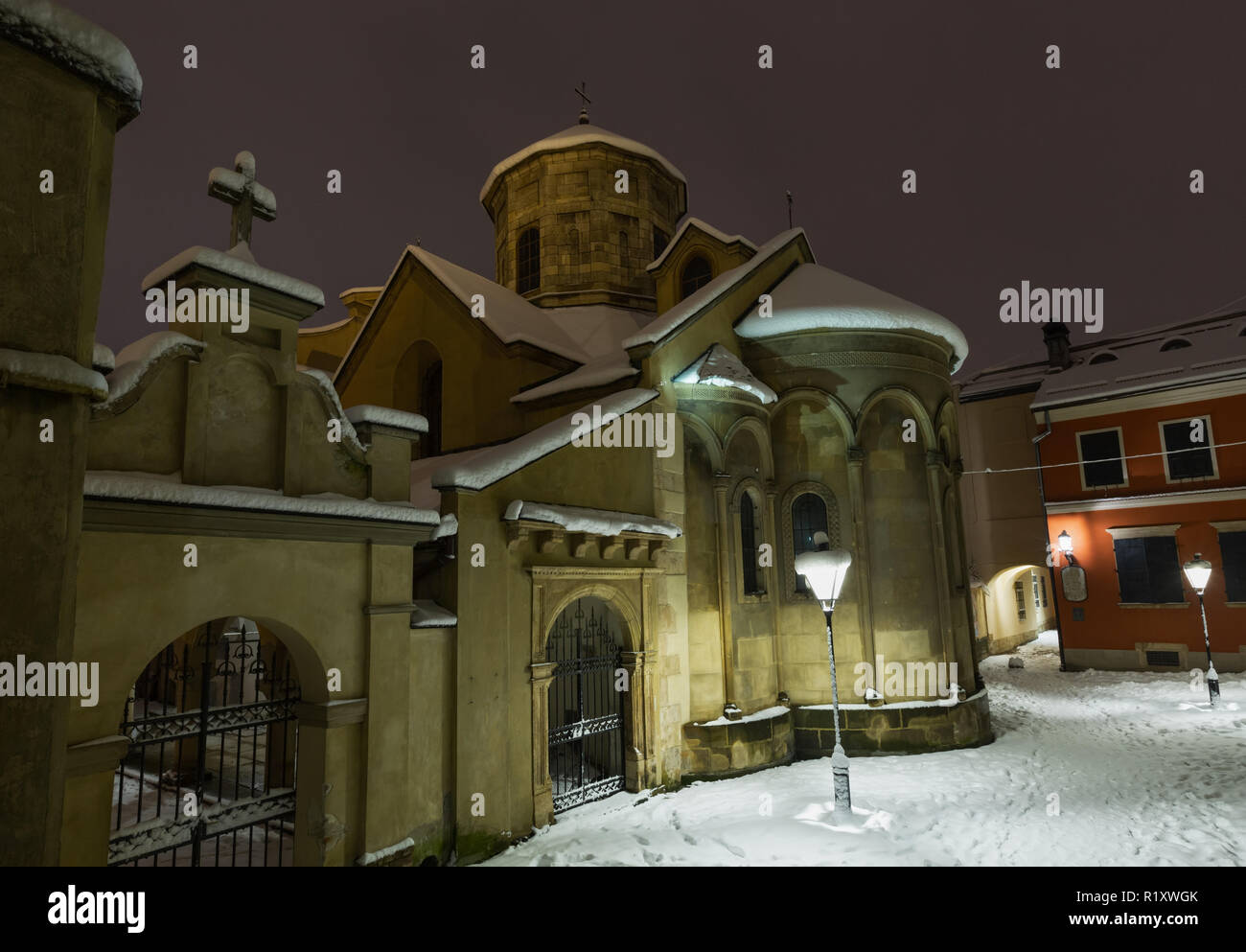 Ancient Armenian church in Lviv City, Ukraine. Beautiful evening twilight winter cityscape. Stock Photo