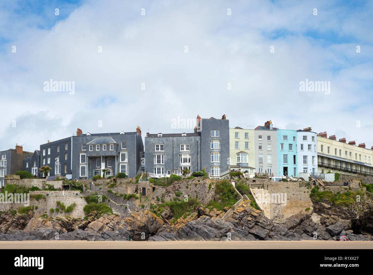 Esplanade - traditional brightly coloured seaside housing, hotels and tourist accommodation above clifftop in resort town of Tenby, Wales, UK Stock Photo