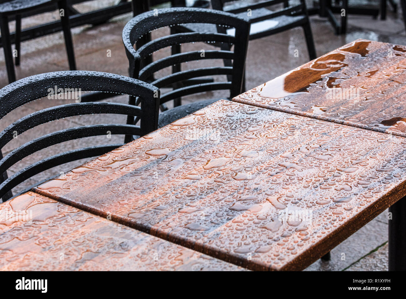 outdoor wet wooden tables and chairs under the rain Stock Photo Alamy