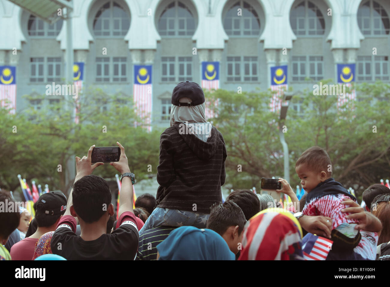 Children shoulder ride their father at Putrajaya during Malaysia independance day celebration 2018 Stock Photo