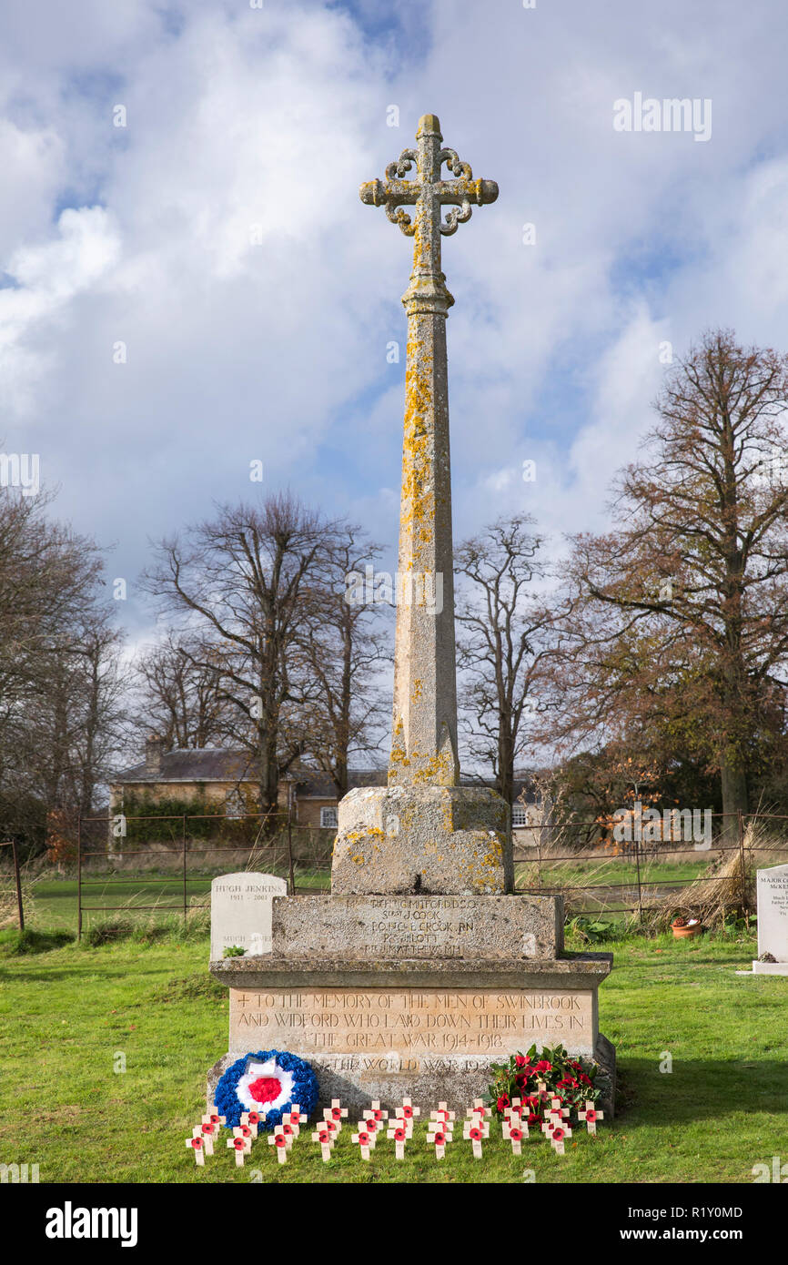 Remembrance wreath and crosses with poppies at war memorial for The Great War 1914-1918 - World War I and World War II 1939-1945 in the graveyard of S Stock Photo