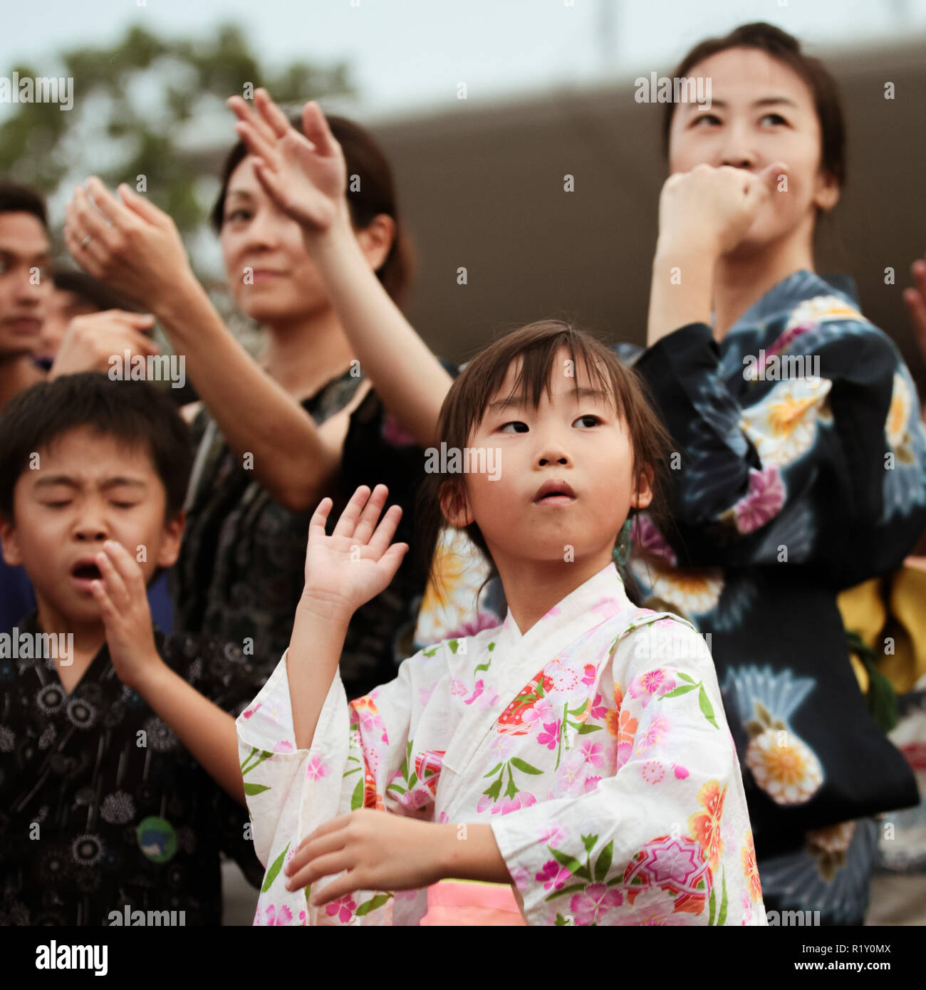 Children in kimono dress dancing to the rhythm of the folk songs in Bon Odori festival. Stock Photo