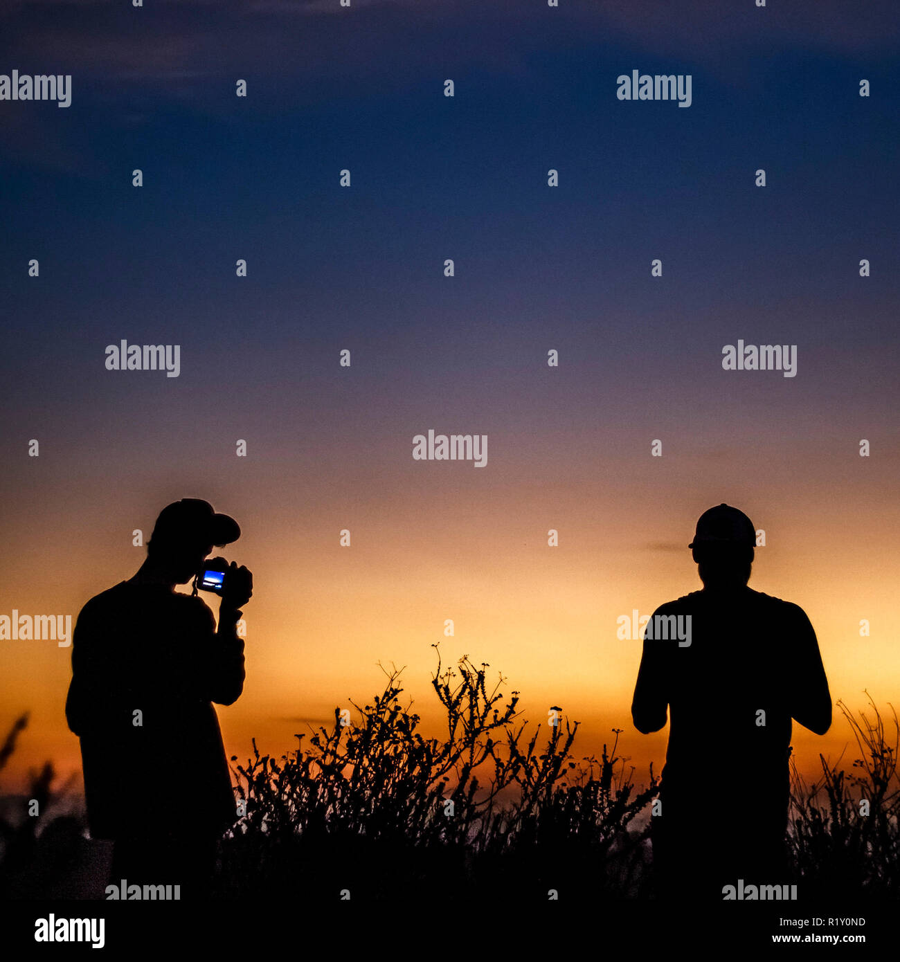 Silhouette two men hiking hi-res stock photography and images - Alamy