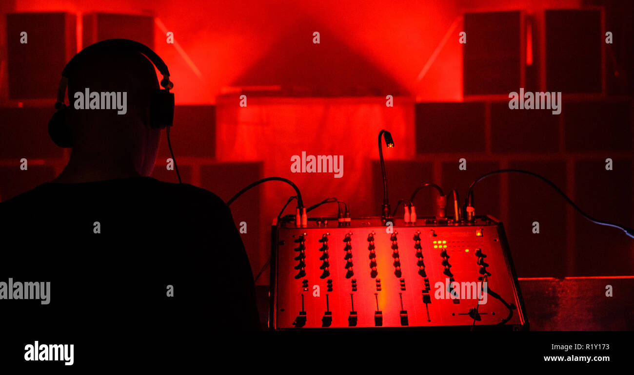 A sound engineer wears headphones and is making a sound check before a