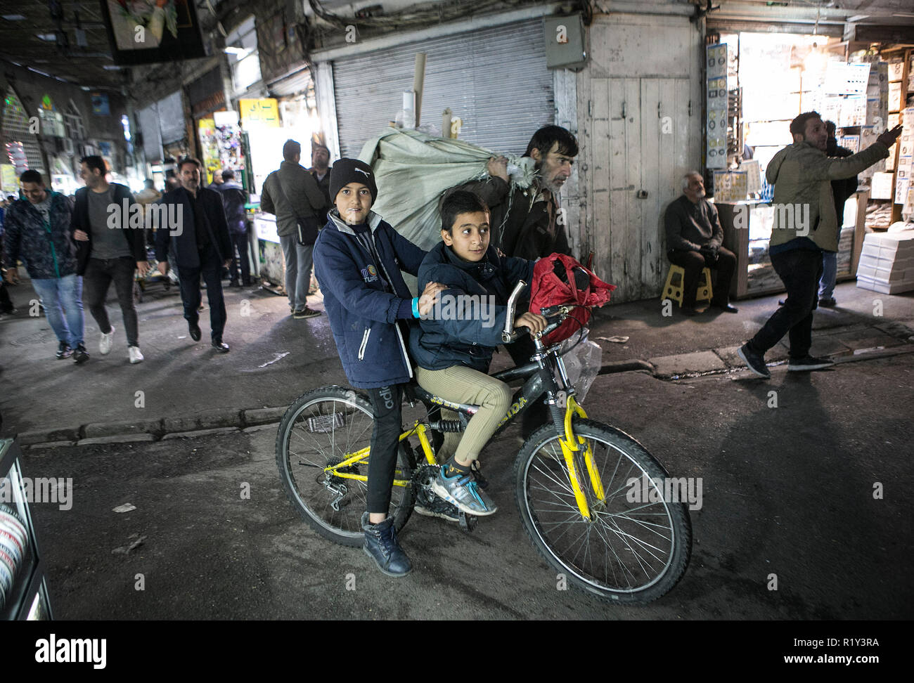 Tehran, Iran. 14th Nov, 2018. Iranian boys ride a bicycle at the Grand