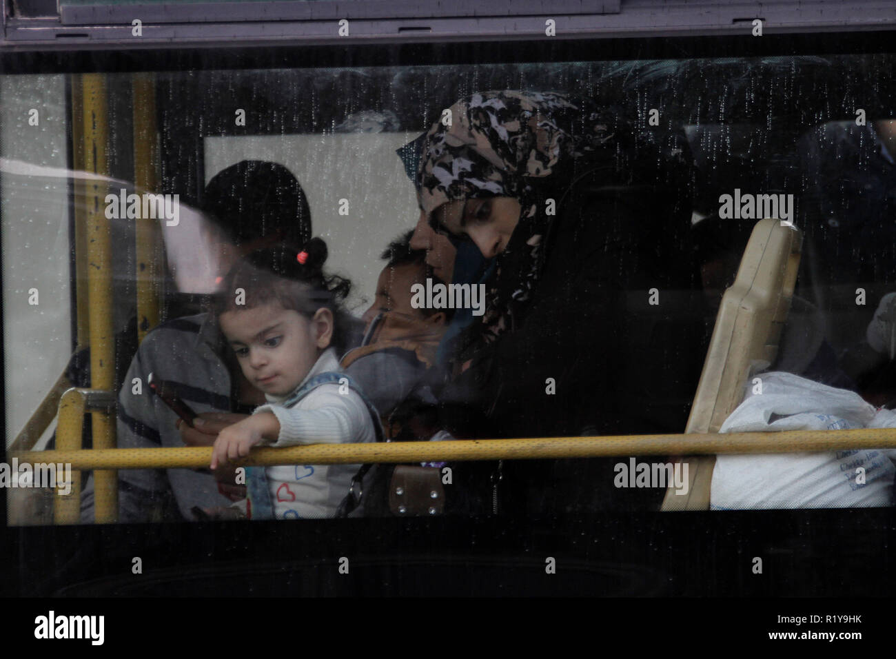 Tripoli. 15th Nov, 2018. People sits in a bus waiting to return to Syria in Lebanon's northern city Tripoli, on Nov. 15, 2018. Over 400 Syrian refugees returned on Thursday to their homeland from areas in Lebanon including Bekaa and Aarsal, local media reported. Credit: Khalid/Xinhua/Alamy Live News Stock Photo