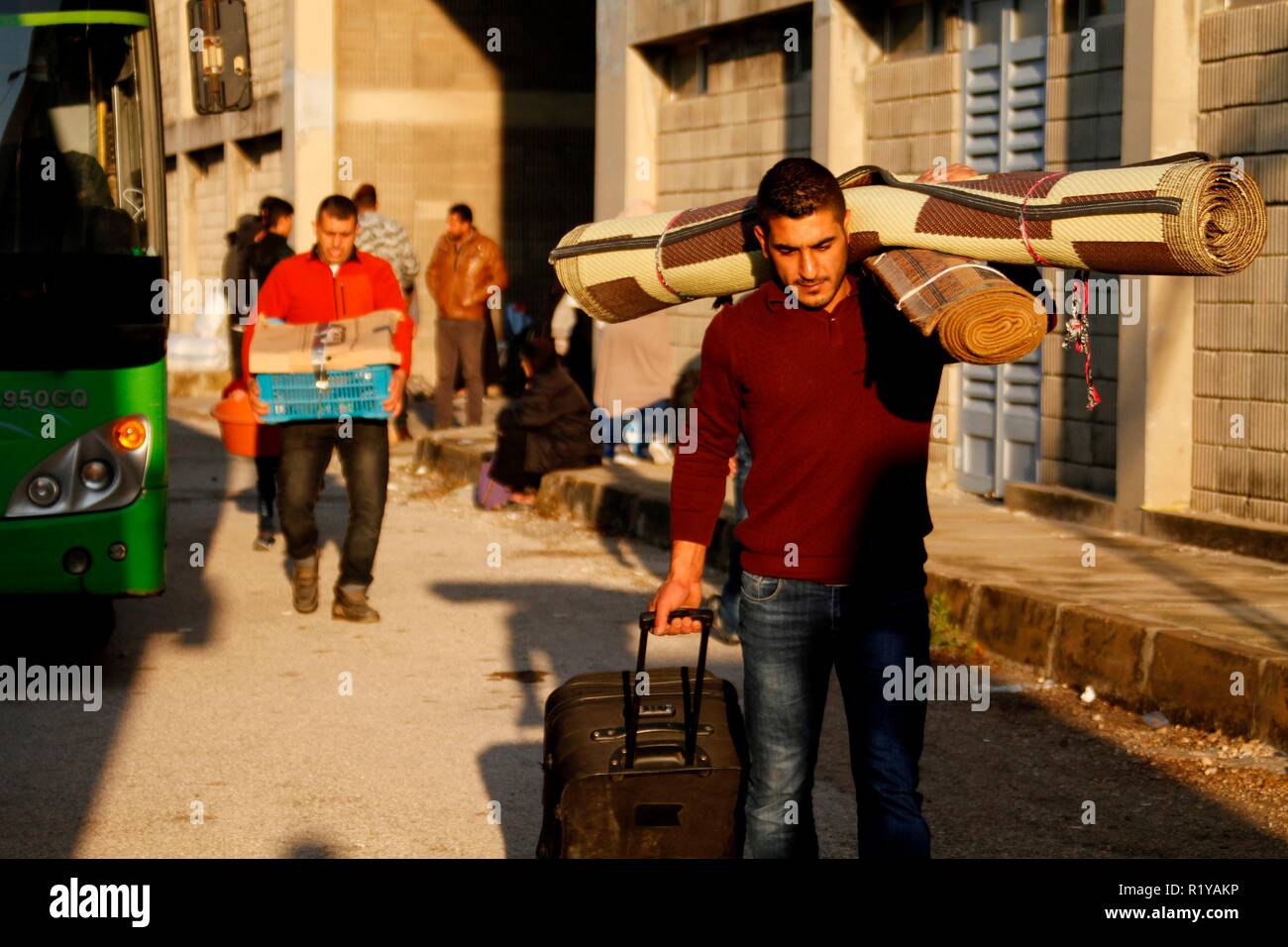Tripoli. 15th Nov, 2018. People carry their belongings waiting to return to Syria in Lebanon's northern city Tripoli, on Nov. 15, 2018. Over 400 Syrian refugees returned on Thursday to their homeland from areas in Lebanon including Bekaa and Aarsal, local media reported. Credit: Khalid/Xinhua/Alamy Live News Stock Photo