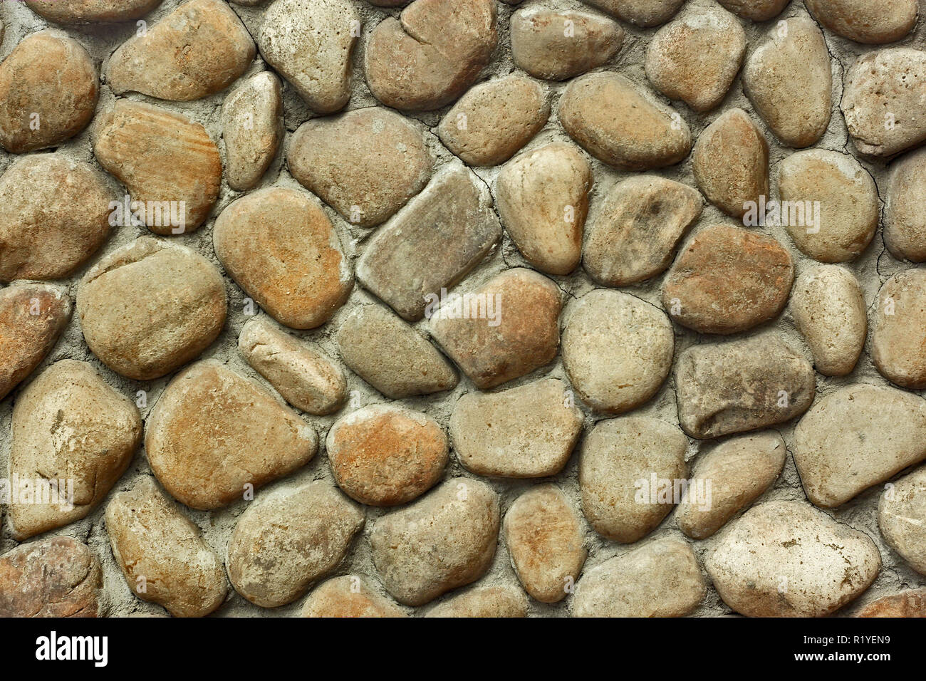 Fragment of old wall with decorative trim from rounded large stone boulders Stock Photo