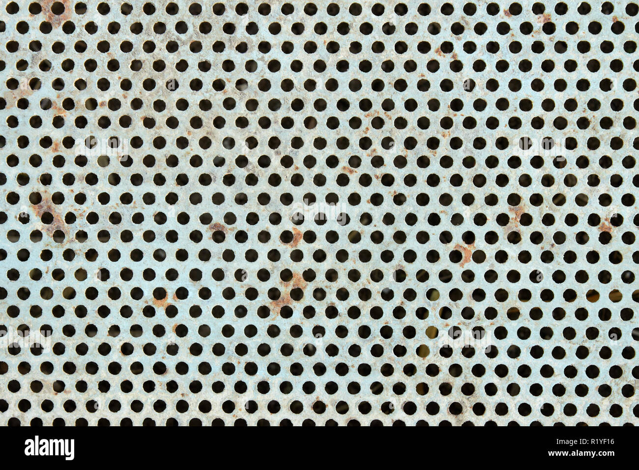 Old metal grate with round holes painted in light blue as a texture Stock Photo
