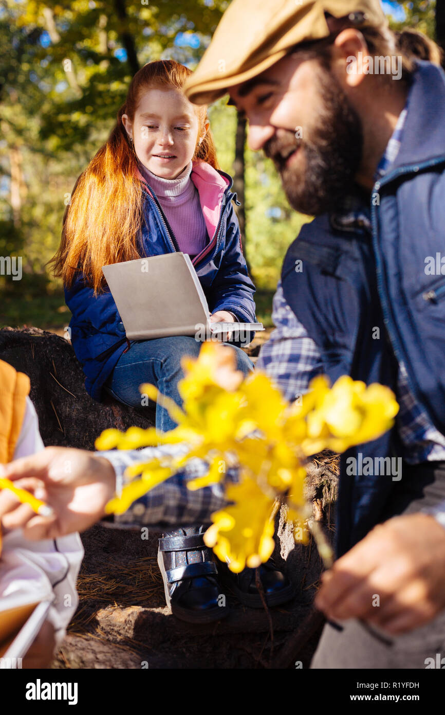 Cute positive nice girl holding her notebook Stock Photo