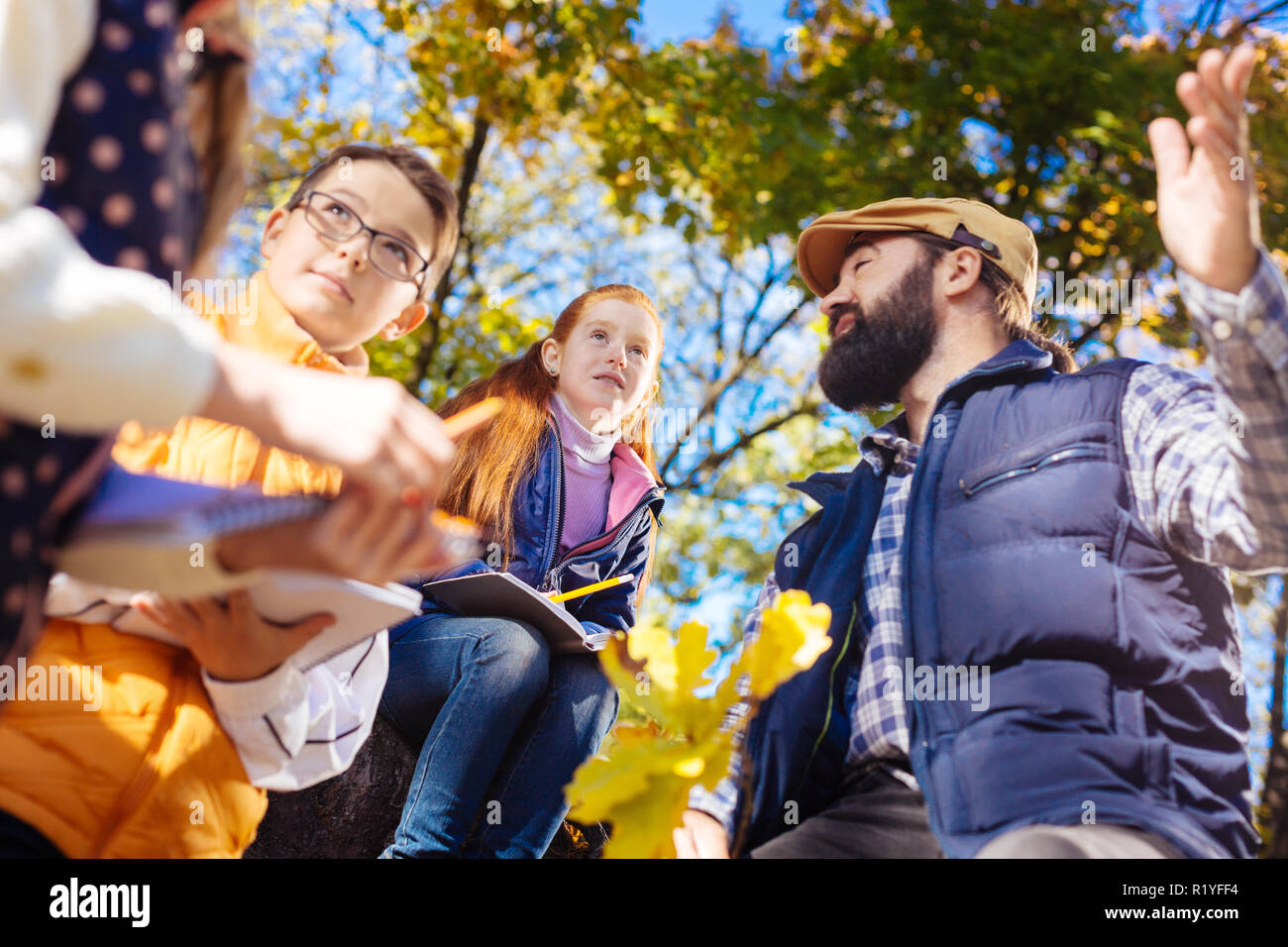 Nice smart children exploring the autumn forest Stock Photo