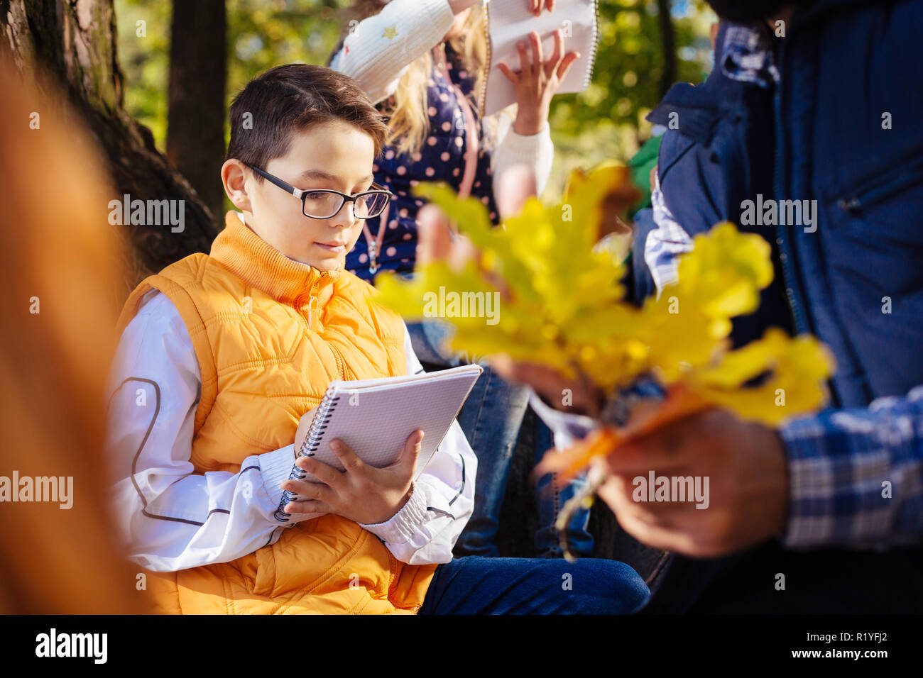 Smart intelligent boy writing in the notebook Stock Photo