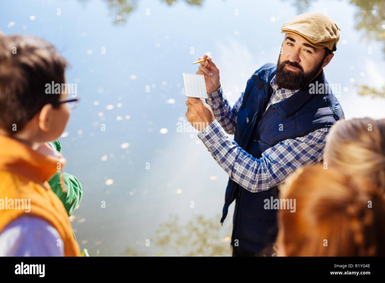 Nice bearded man standing near the lake Stock Photo