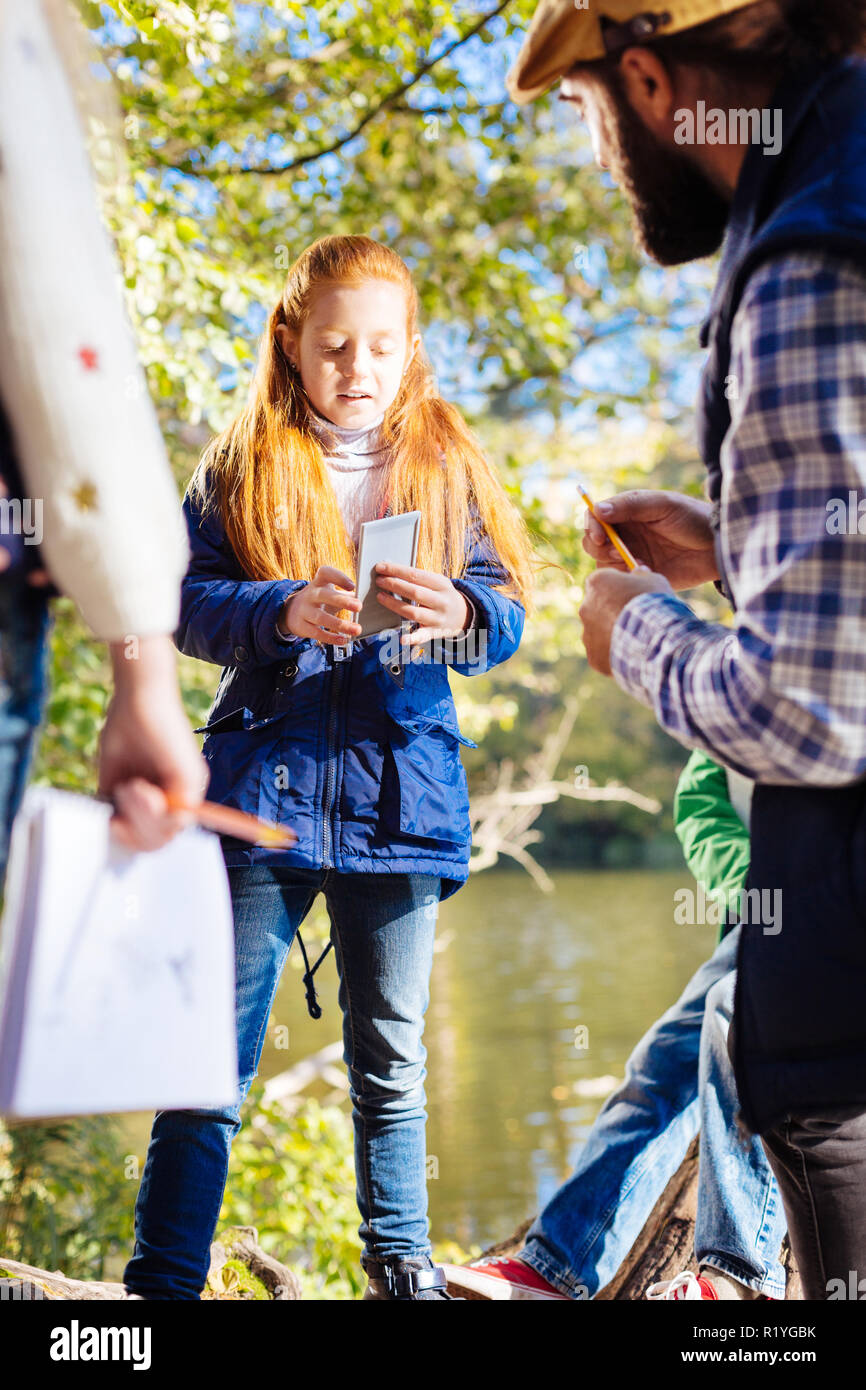 Cute pretty girl holding a special device Stock Photo