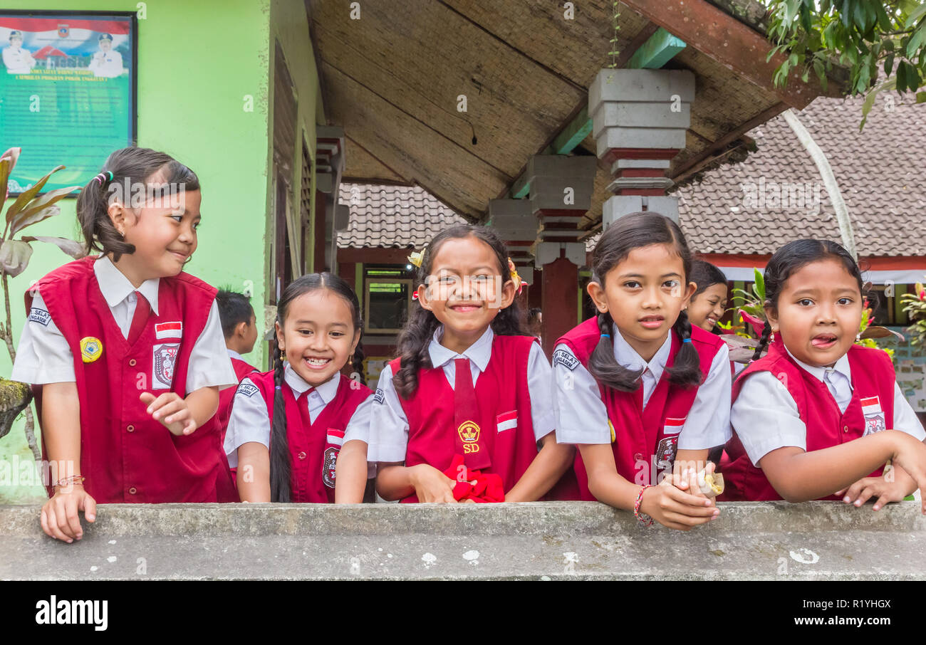 Indonesian schoolgirls in uniform posing in front of their school Stock Photo