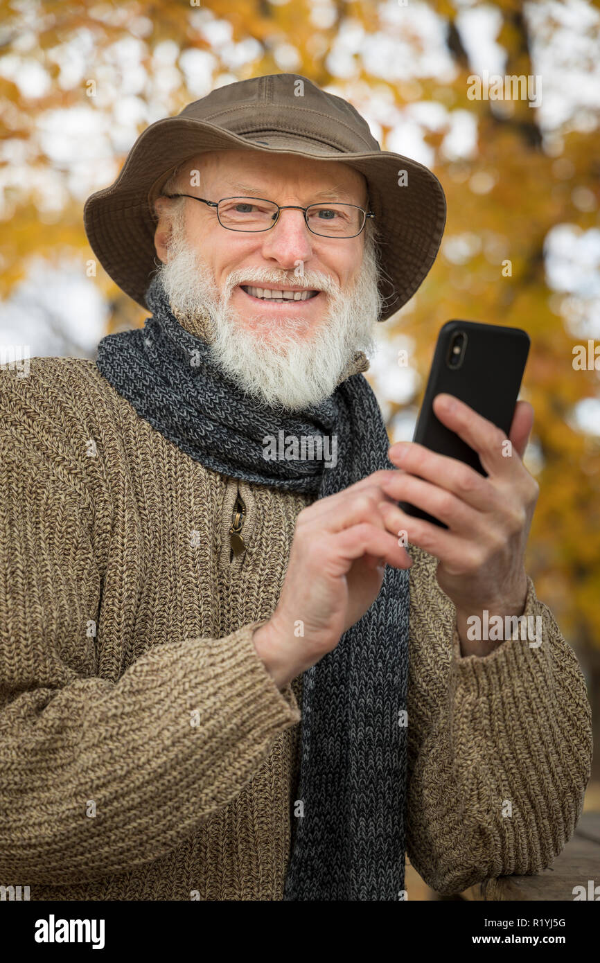 Senior man outdoors using a smartphone Stock Photo