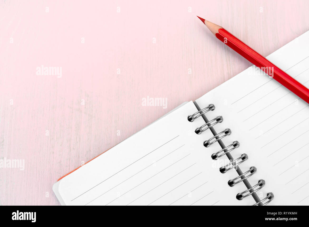 Red pencil and notebook for notes. Stock Photo