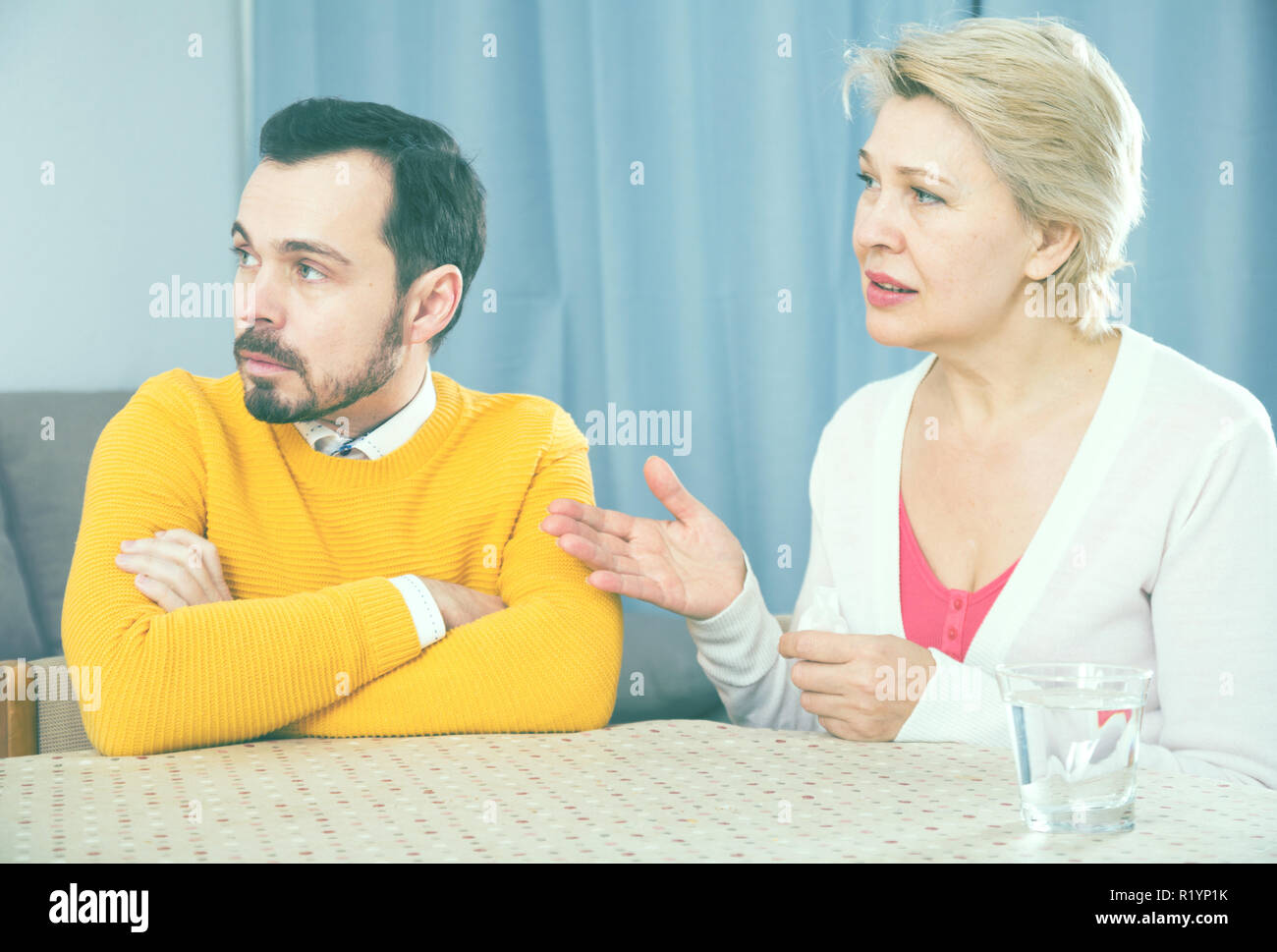 Mature mother and son quarrel and find out relationship Stock Photo