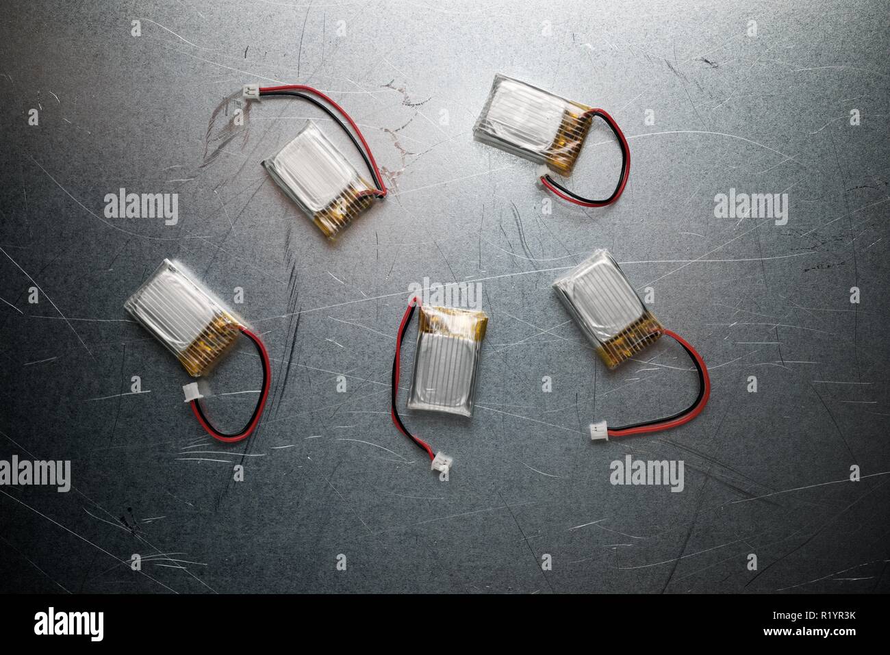 Drone batteries on a metal table. Stock Photo