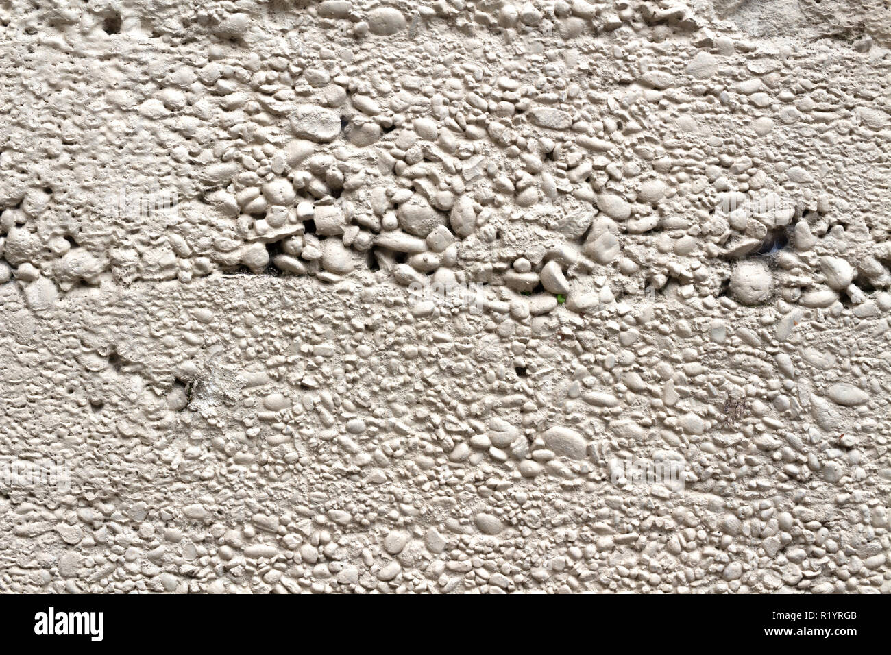 Concrete wall pattern made with bigger pebbles than usual Stock Photo