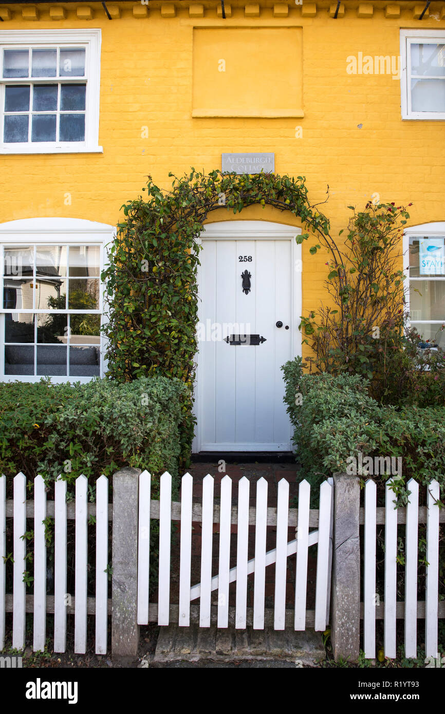 Colourful Suffolk seaside home with traditional white paling fence in Aldeburgh, England, UK Stock Photo
