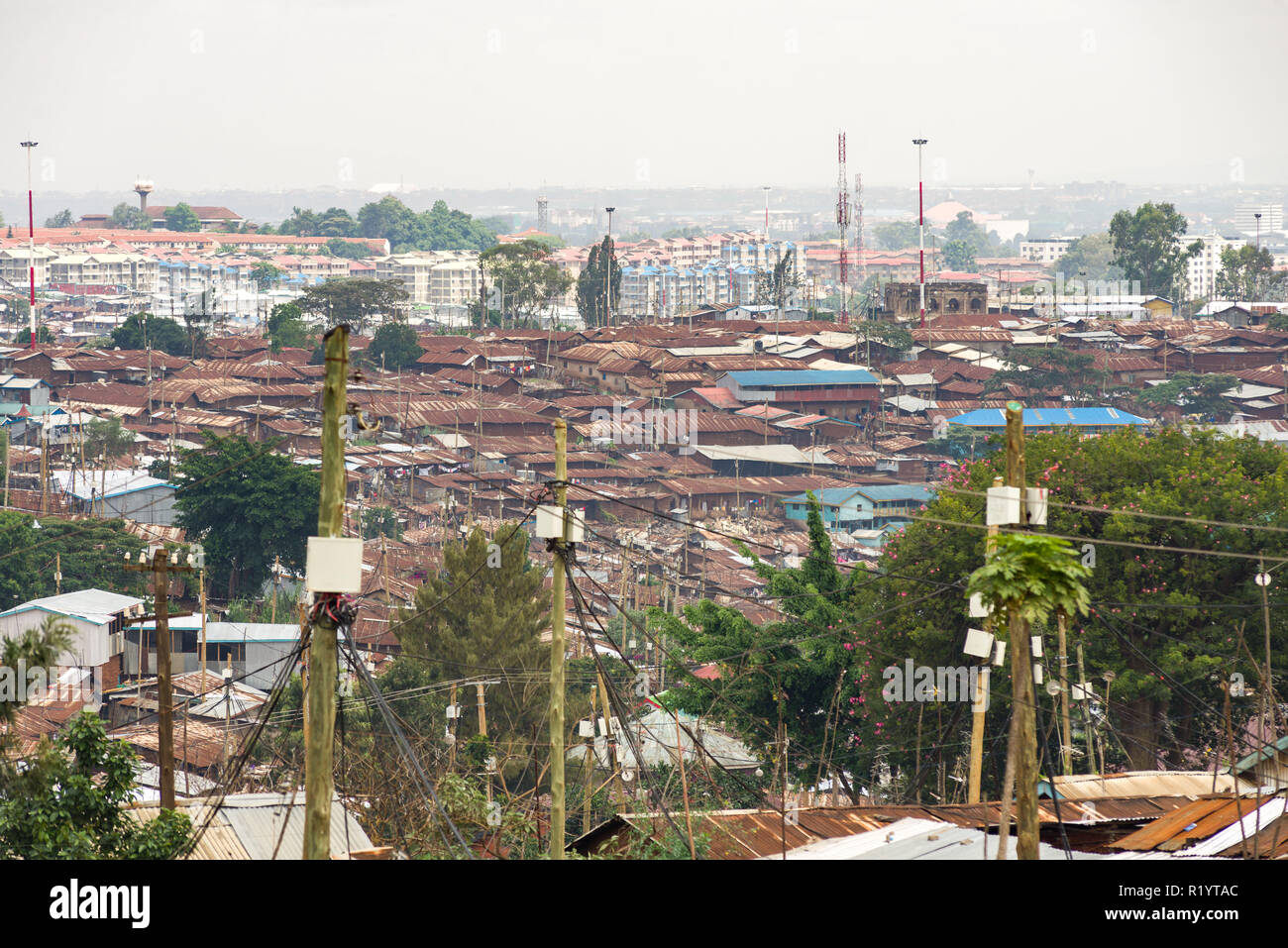 View across the roofs of Kibera slum and Nairobi city in the background, Kenya Stock Photo