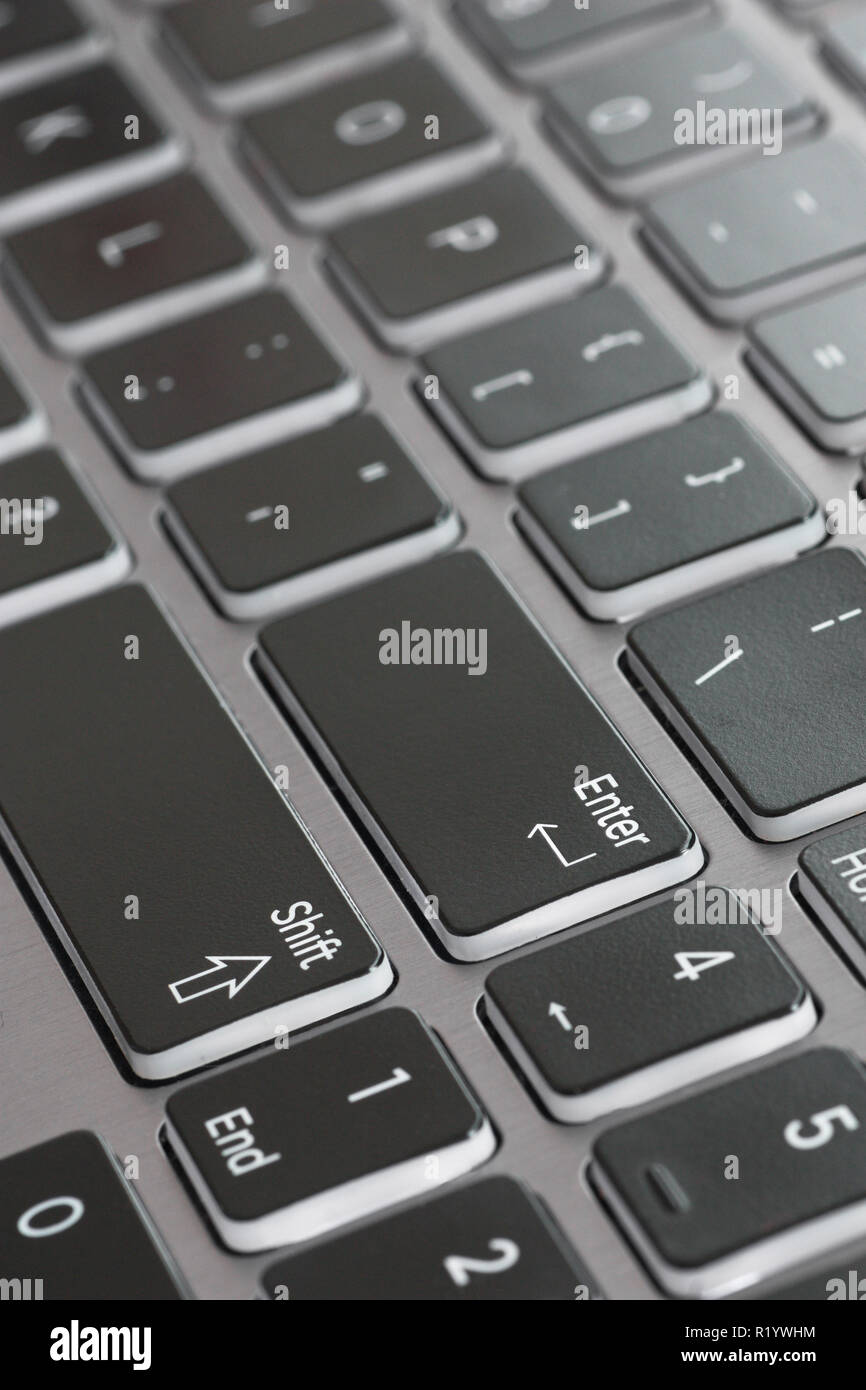 Laptop keyboard macro close up fading enter shift key focused Stock Photo