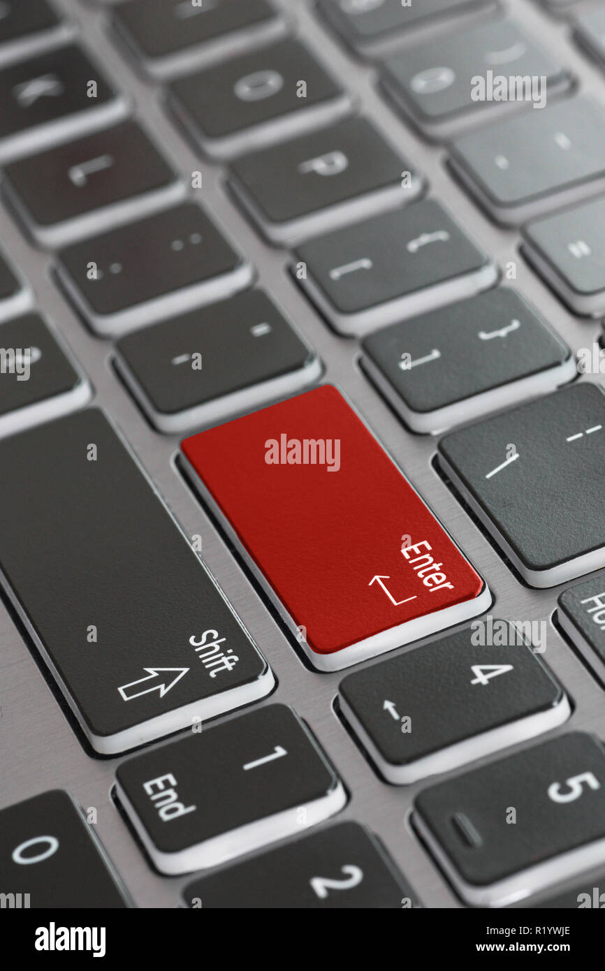 Laptop keyboard macro close up fading enter shift key focused red enter key Stock Photo