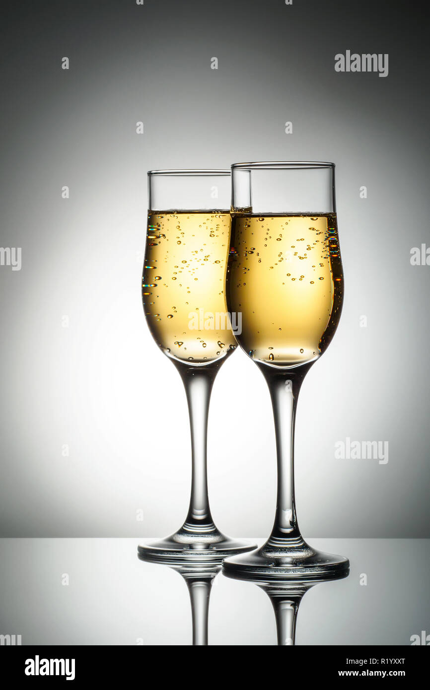 Two elegant glasses with sparkling champagne Holiday card Christmas, New Year, wedding. Celebration concept advertising design Stock Photo