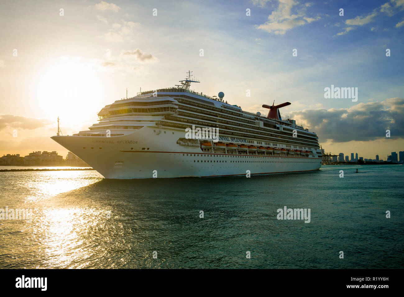 MIAMI - CIRCA AUGUST, 2018: The Carnival Victory Cruise ship passes in front of the city skyline during a sunset departure. Stock Photo