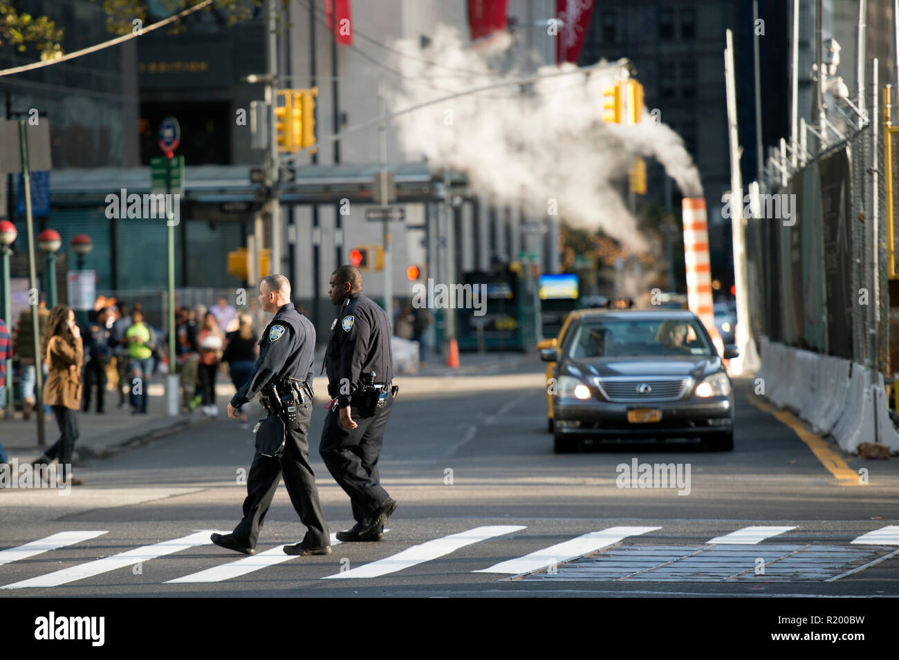 NEW YORK - USA - 28 OCTOBER 2017. Two police officers are crossing the street near the World Trade Center 'Ground Zero' in Manhattan, New York. Stock Photo