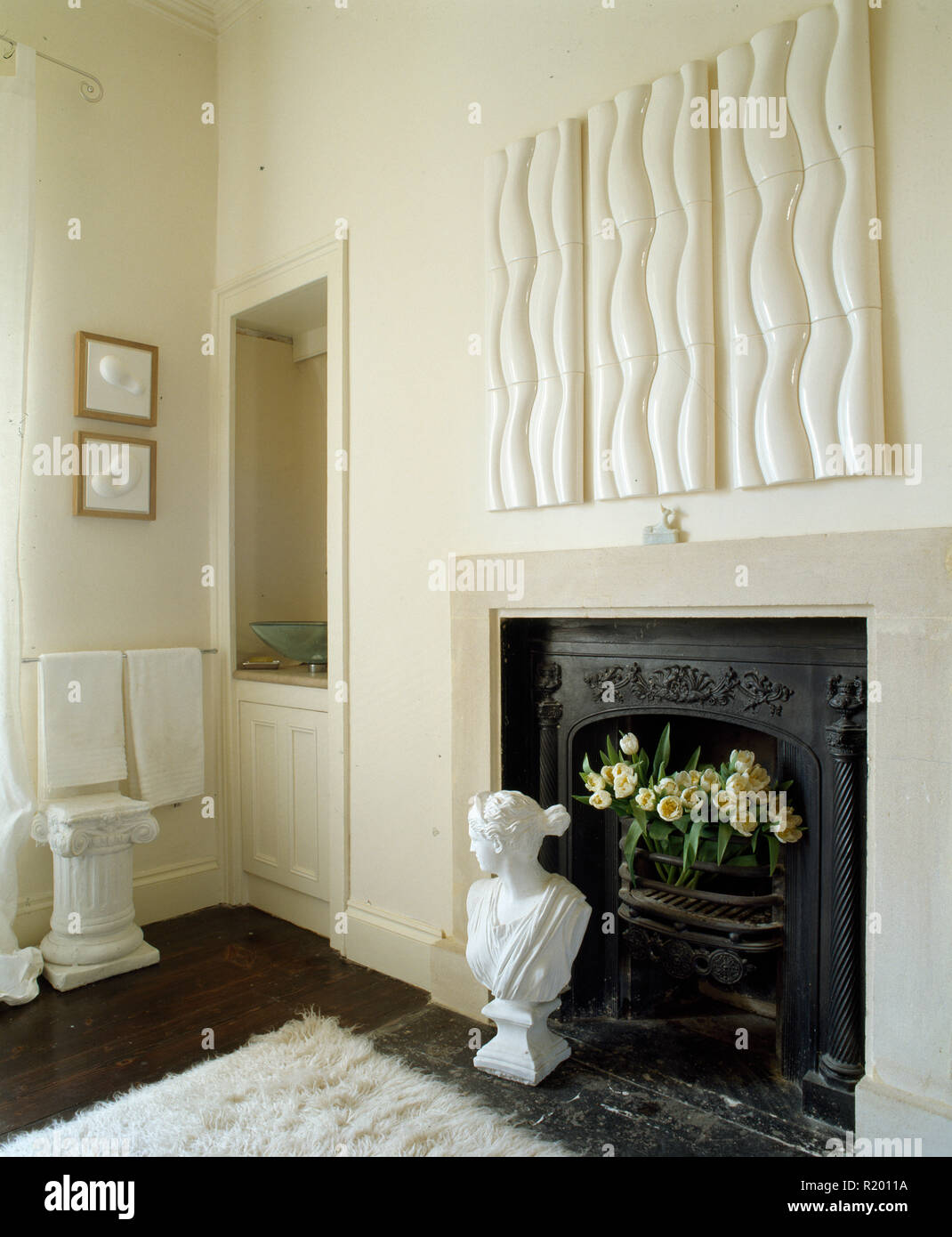 Modern artwork above fireplace with classical bust Stock Photo Alamy