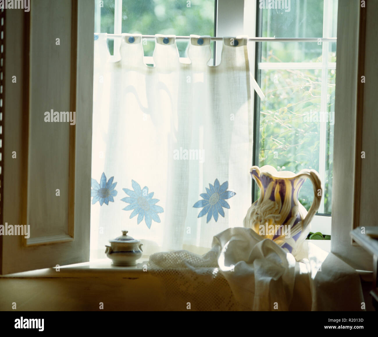 Vintage Jug On Windowsill Below White Cafe Curtain Stock Photo