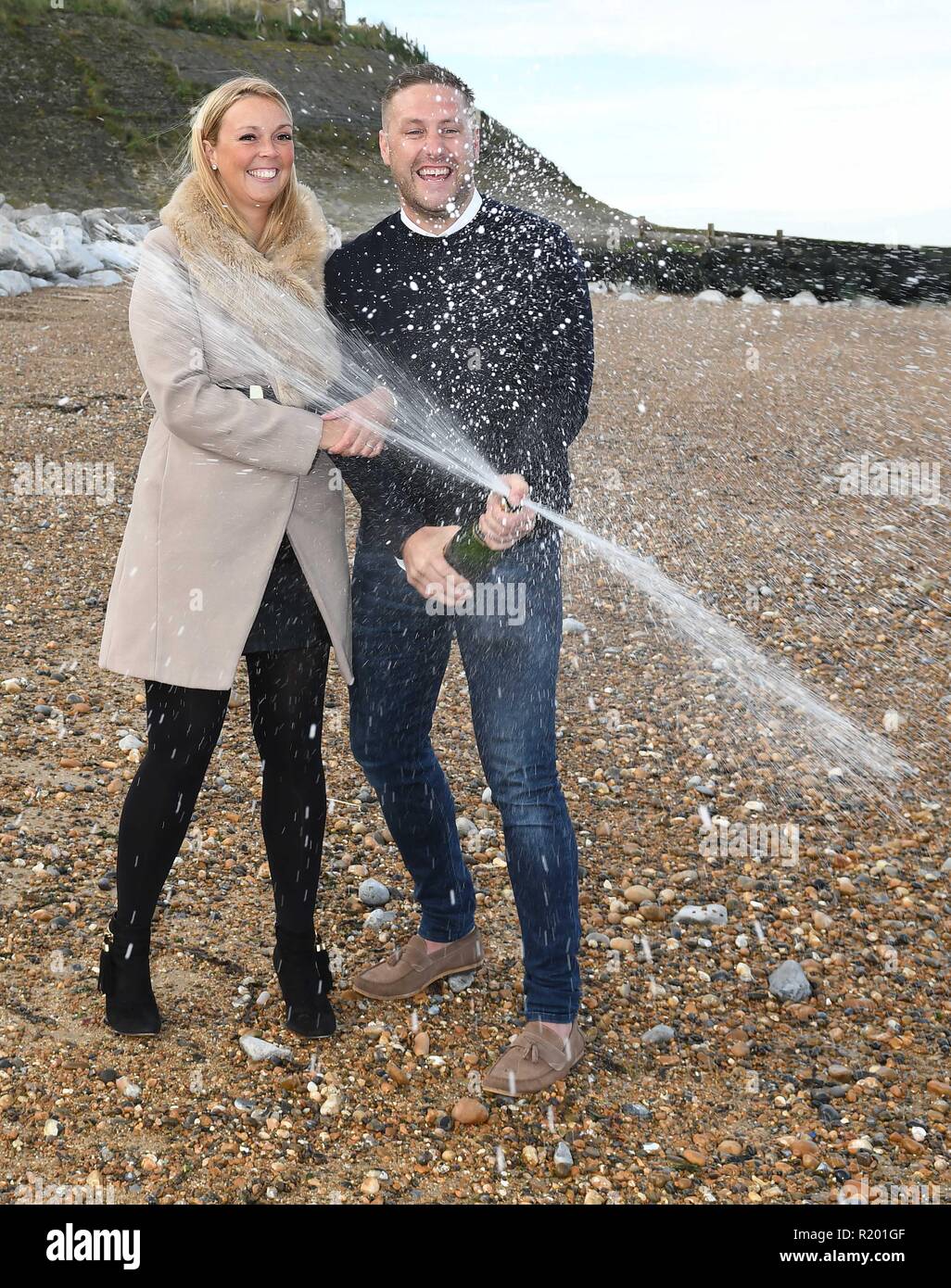 Mick Tyler, 35, and his fiancee Sarah Harmer, 33, winners of the One Million Pound Lotto Raffle, pictured on the beach where Mick proposed to Sarah last Christmas Eve, at Reculver in Kent.  Featuring: Mick Tyler, Sarah Harmer Where: Reculver, Kent, United Kingdom When: 12 Oct 2018 Credit: Steve Finn/WENN Stock Photo