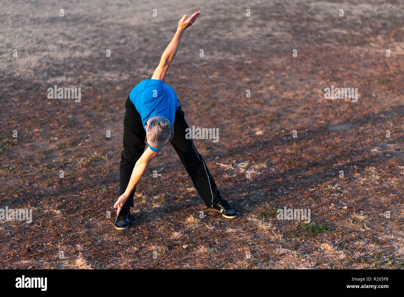 Fitness mature man stretching hi-res stock photography and images - Alamy