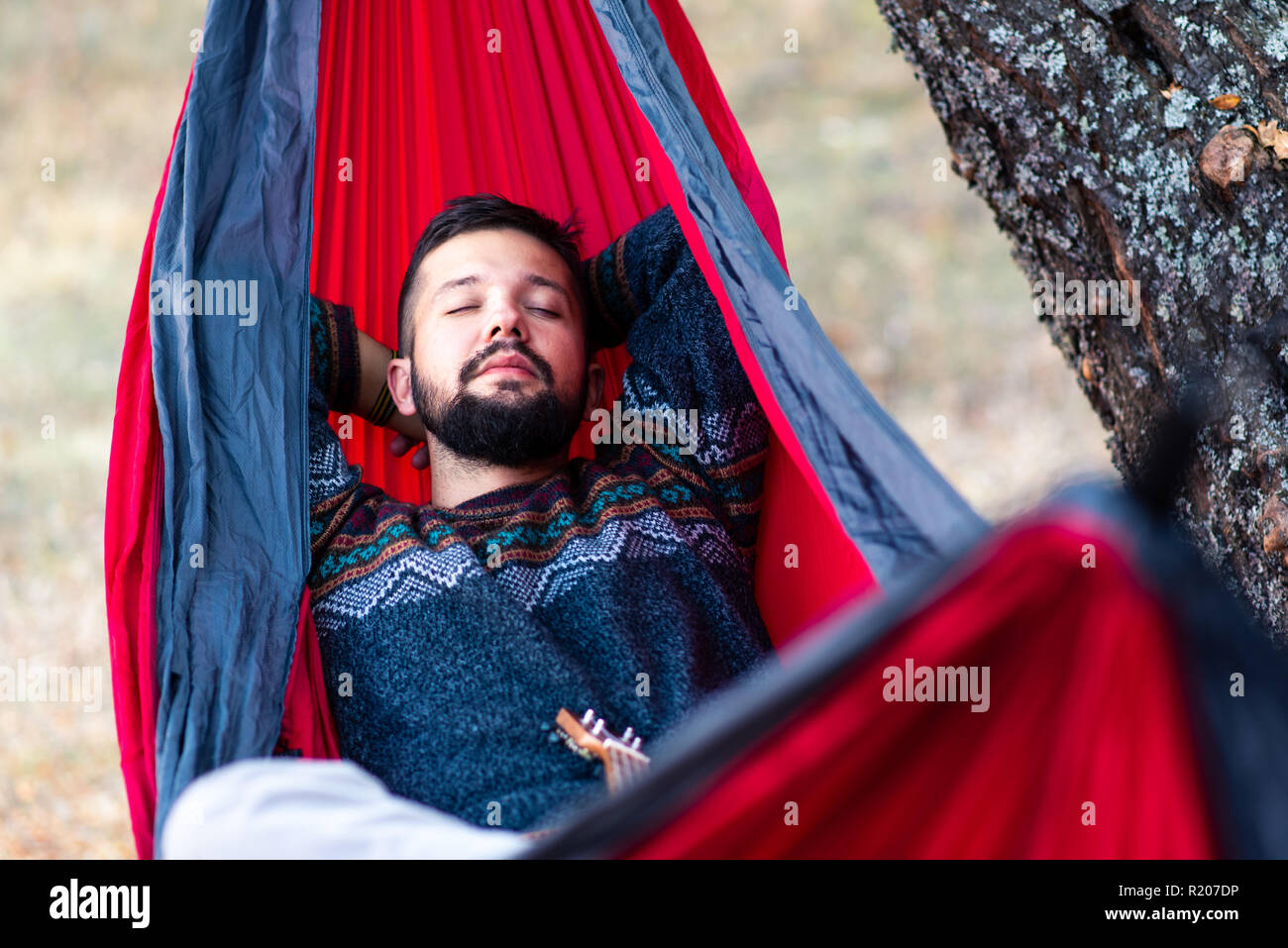 Man relaxing in a hammock on a hiking trip Stock Photo
