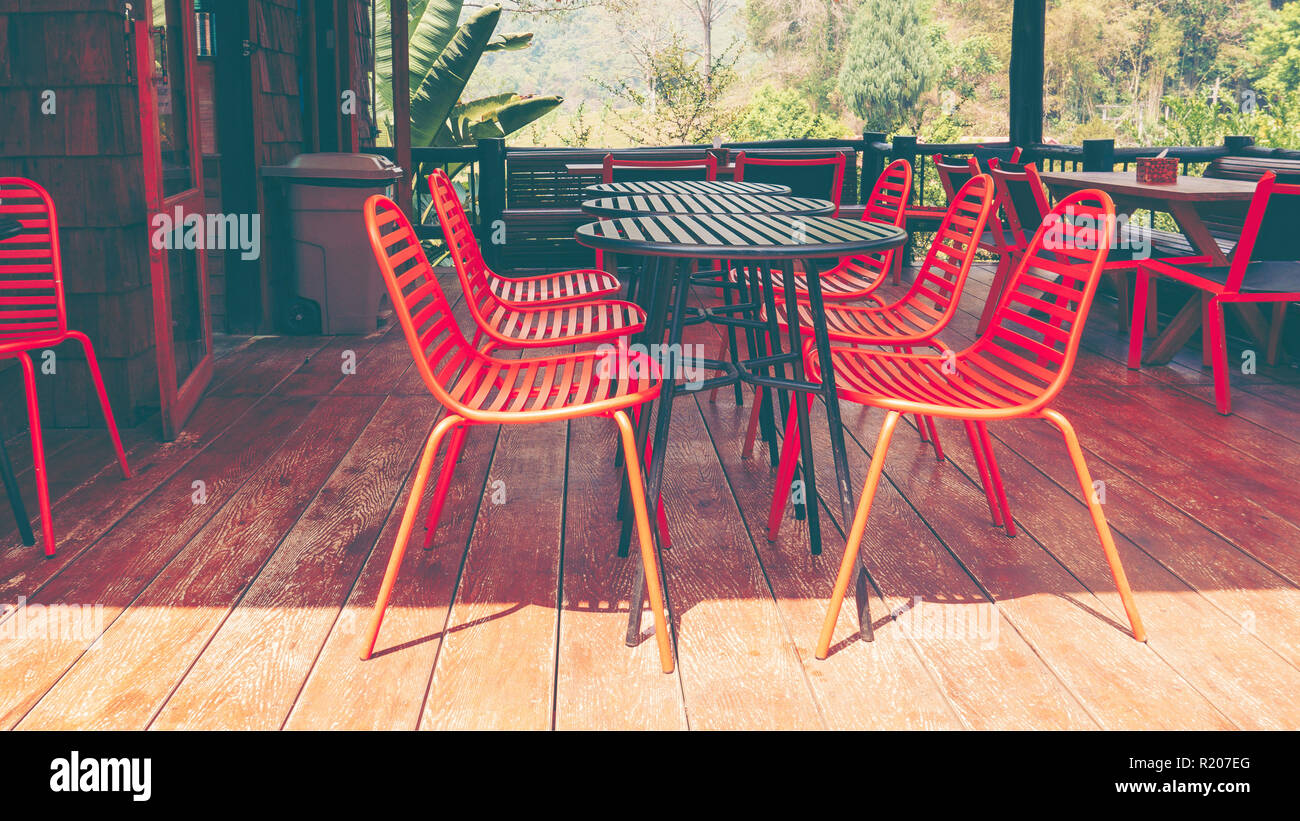 Orange outdoor table & chairs in bistro café in daytime for relaxation, travel, season, time, holiday, gastronomy, concept Stock Photo