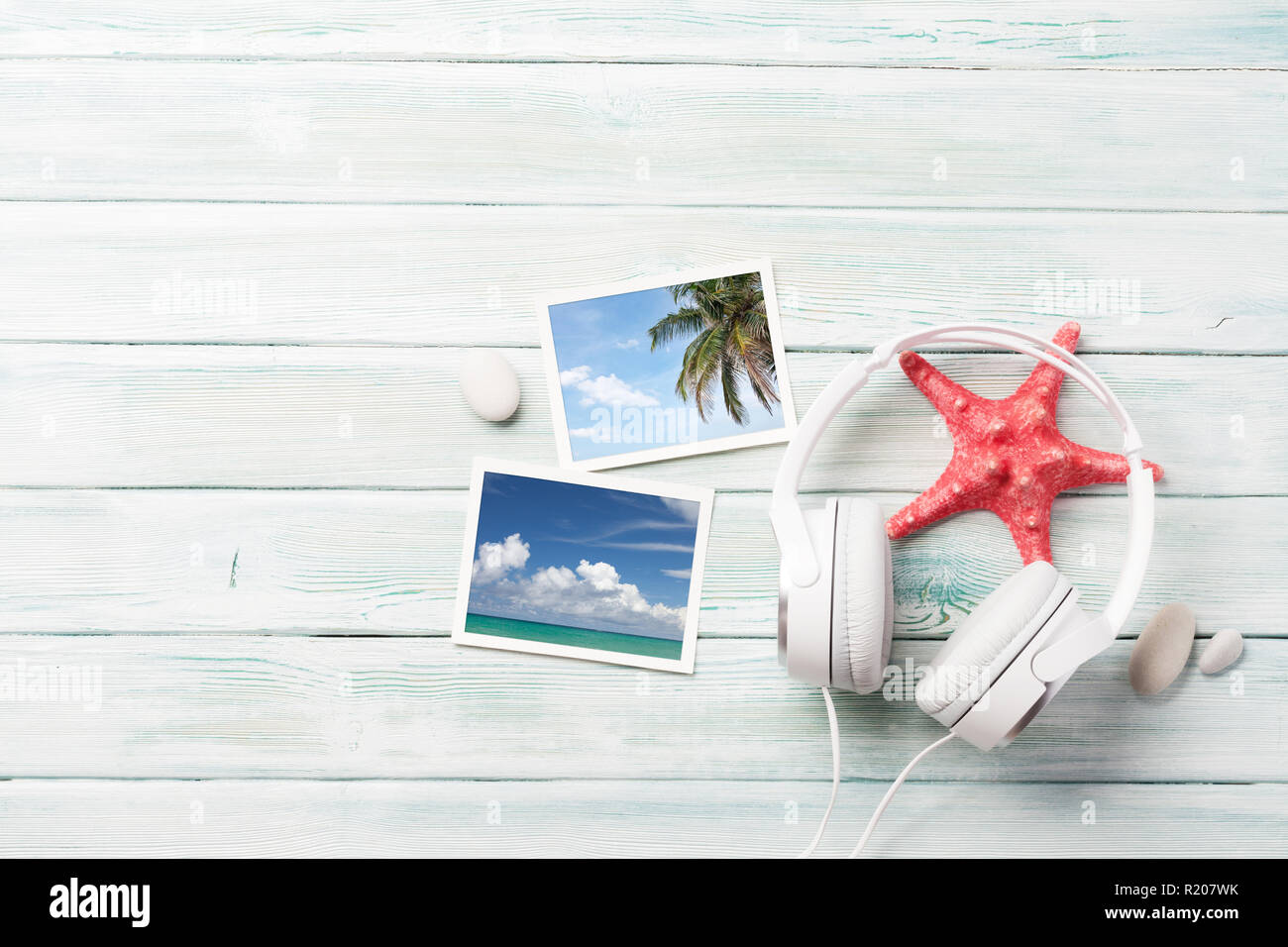 Travel vacation and music concept with headphones, starfish and photos on wooden backdrop. Top view with copy space. Flat lay. All photos taken by me Stock Photo