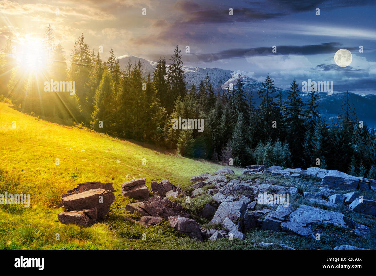 alpine summer landscape day and night time change composite. rock formation near the spruce forest on a grassy hill.  mountain with snowy top in the d Stock Photo