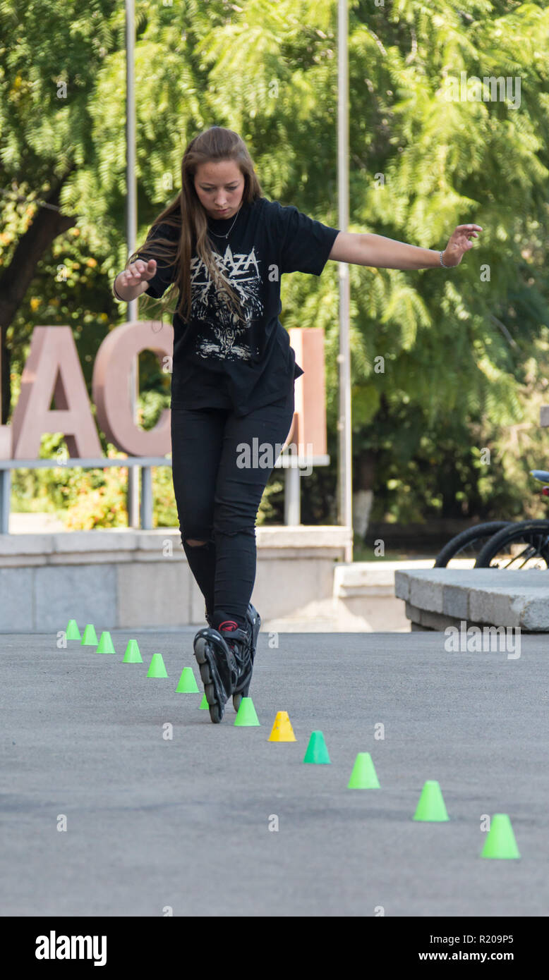 KAZAKHSTAN ALMATY - AUGUST 28, 2016: Urban extreme competition, where the city athletes compete in the disciplines: skateboard, roller skates, BMX. Bmx stunt performed at the top of a mini ramp on a skatepark.Get Away from the Office! - wide-angle shot, little motion blur Stock Photo
