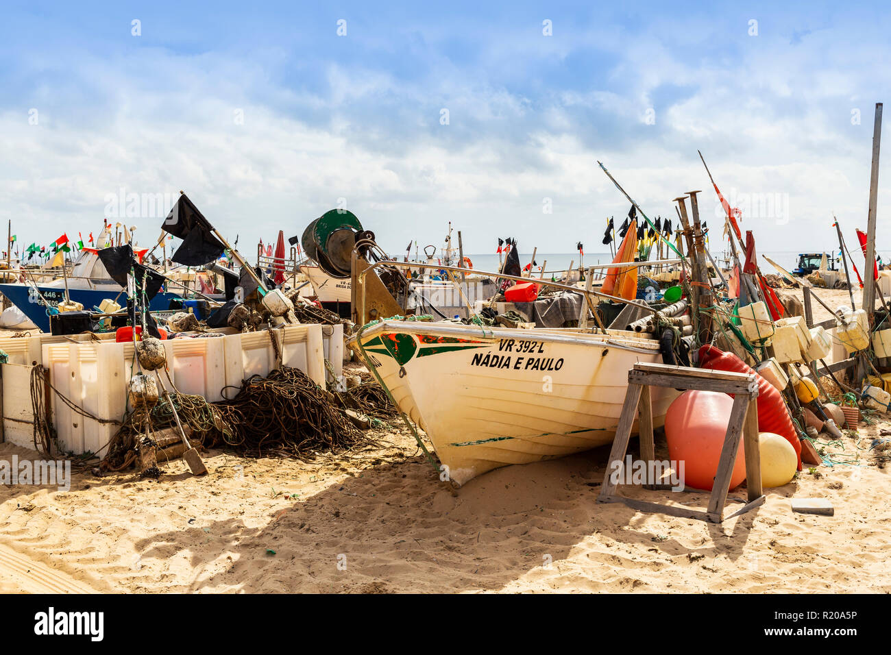 Local traditional fishing boats on the beach at Monte Gordo, Algarve ...