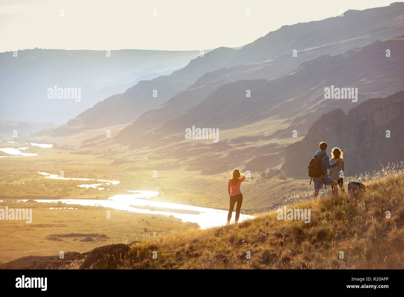 Group of tourists is having rest and looking at view in mountains area Stock Photo