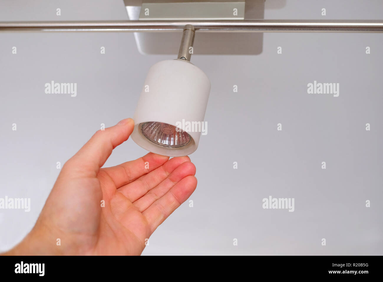 Electrical engineers are installing ceiling lamps in the hallway. Stock Photo
