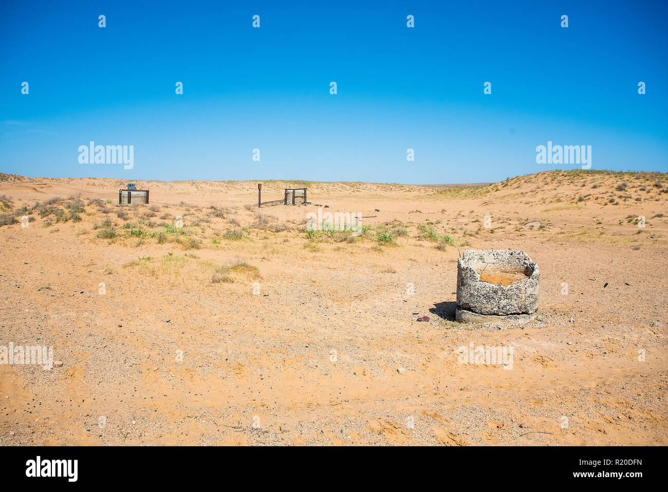 View of old stone water wells in semidesert Stock Photo Alamy