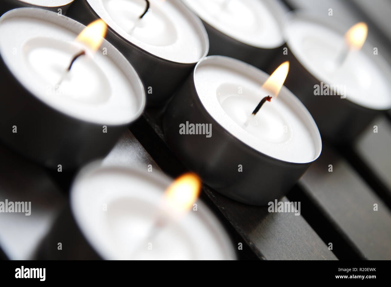 Tea lights on a wooden bench Stock Photo